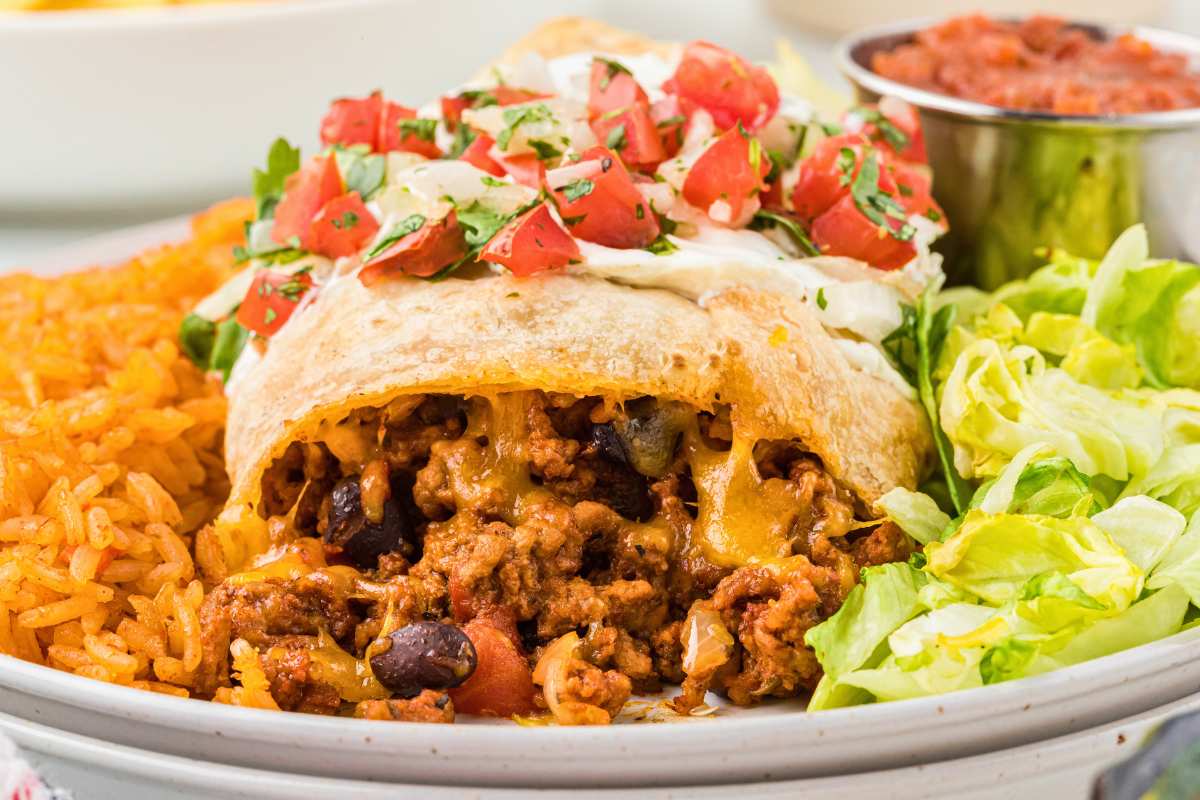 chimichanga on plate with filling visible.