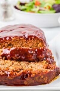 front of meatloaf with barbecue sauce on top and two slices cut.