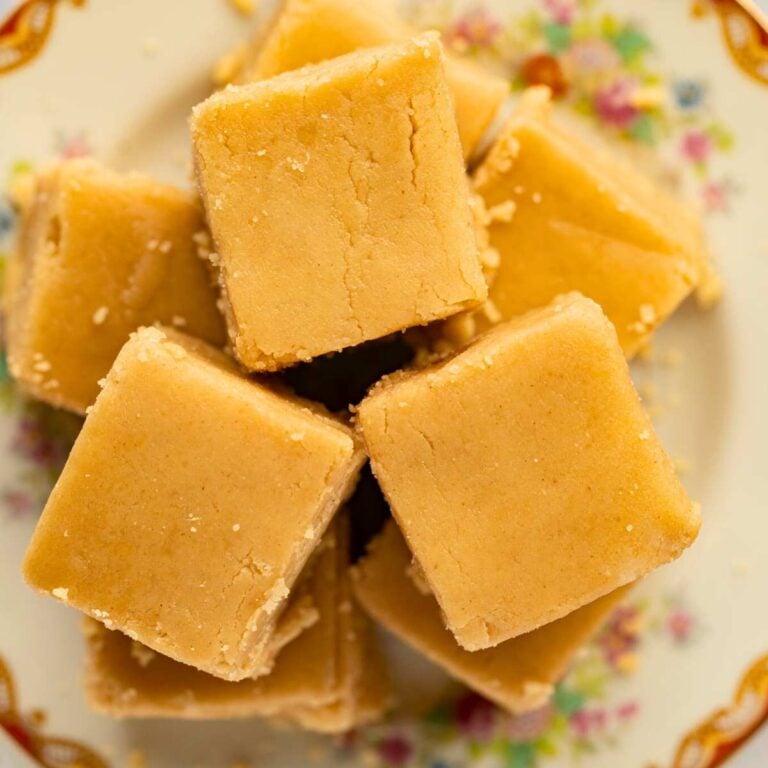 squares of peanut butter fudges arranged on plate.
