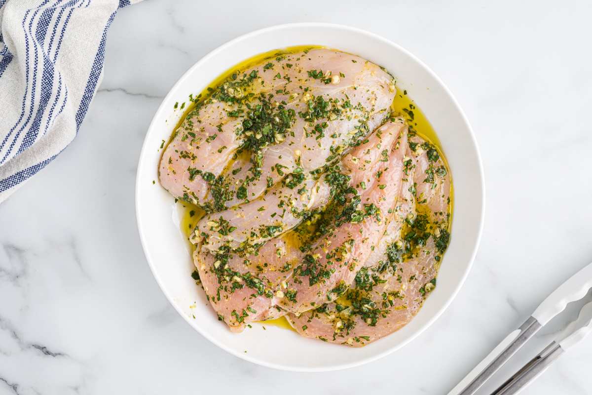 chicken marinaded in bowl.