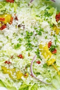 close up of salad all mixed with cheese on top.