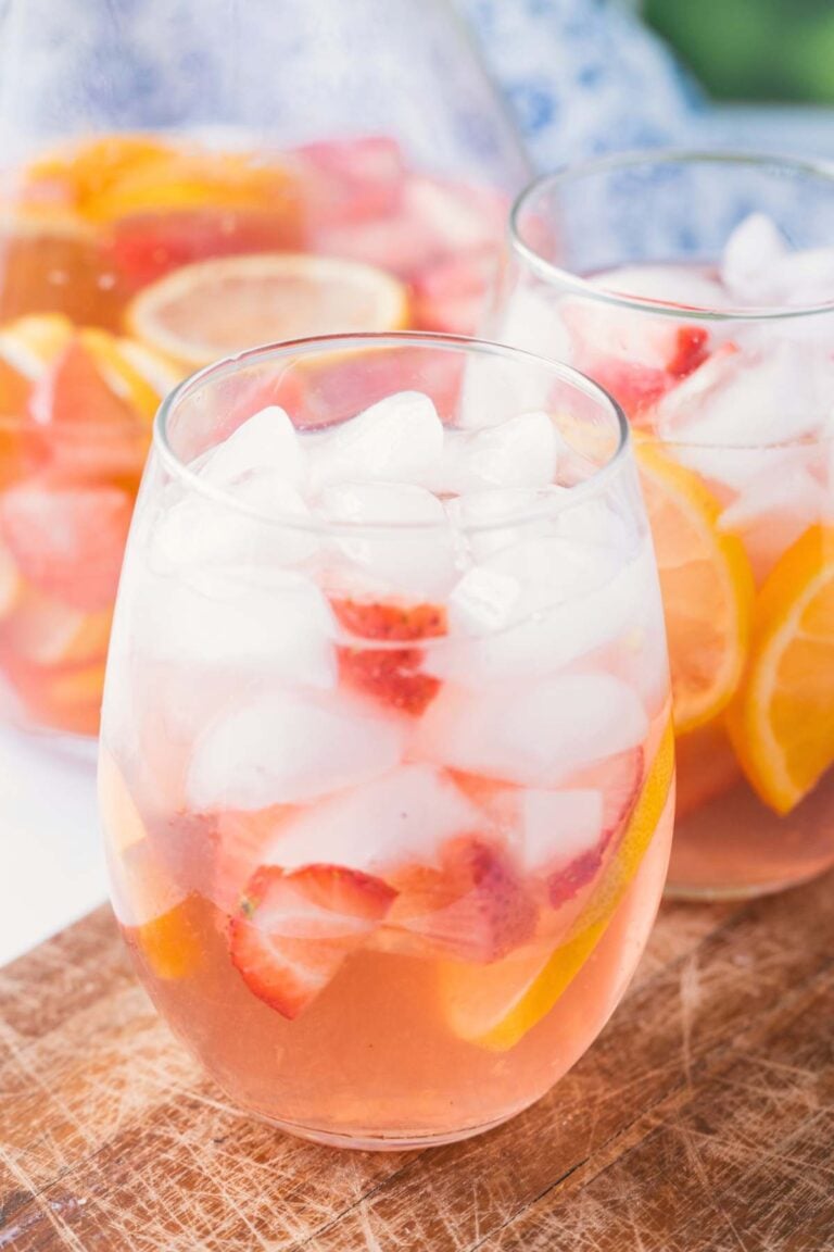 Two glasses of sangria with pitcher and background