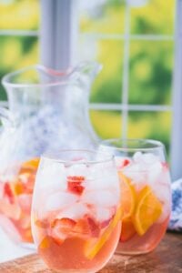 glasses and pitcher of strawberry rose sangria.