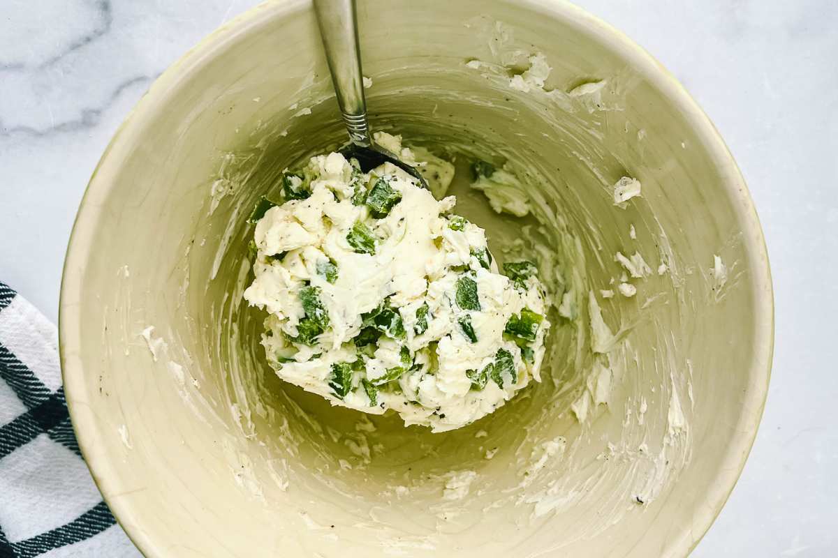 cream cheese and jalapeños mixed together in bowl.