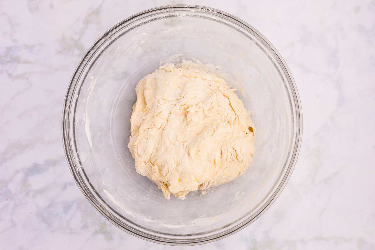 dough shaped into ball in mixing bowl.