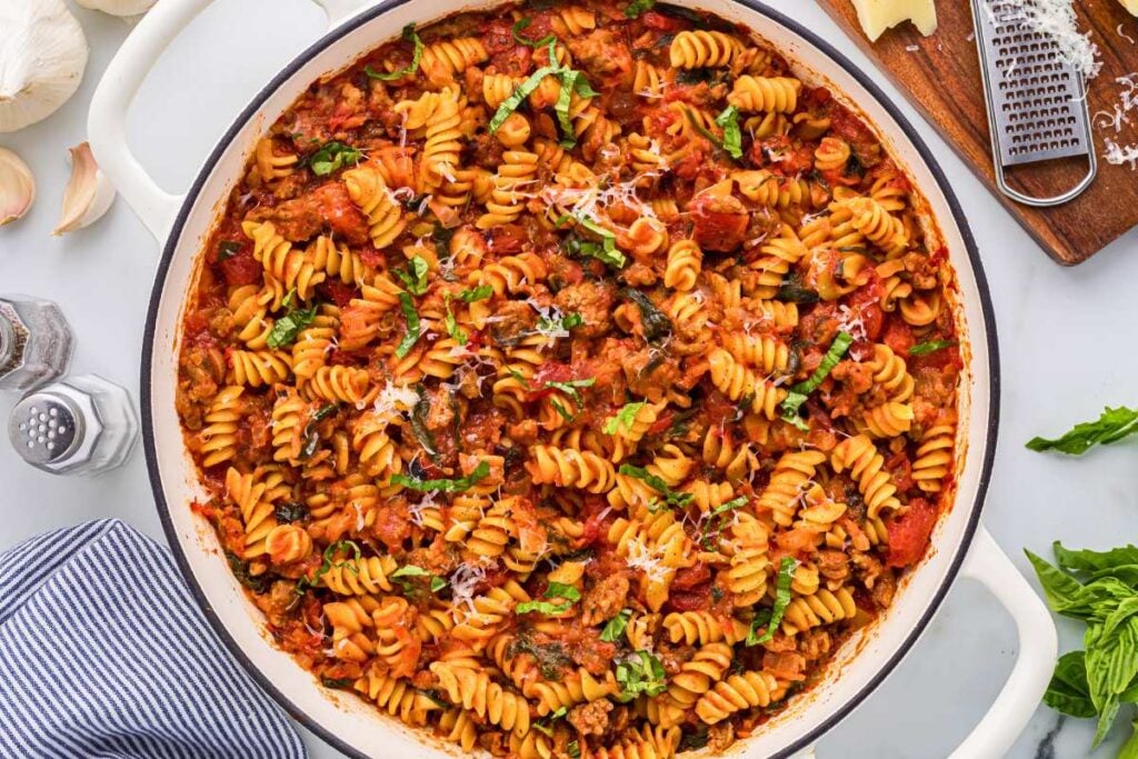 finished pasta in pot topped with freshly grated Parmesan.