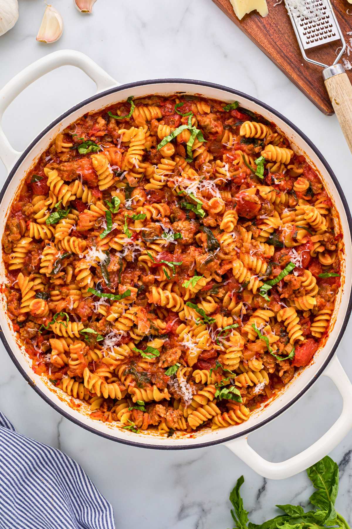 top view of finished sausage pasta topped with grated Parmesan. 