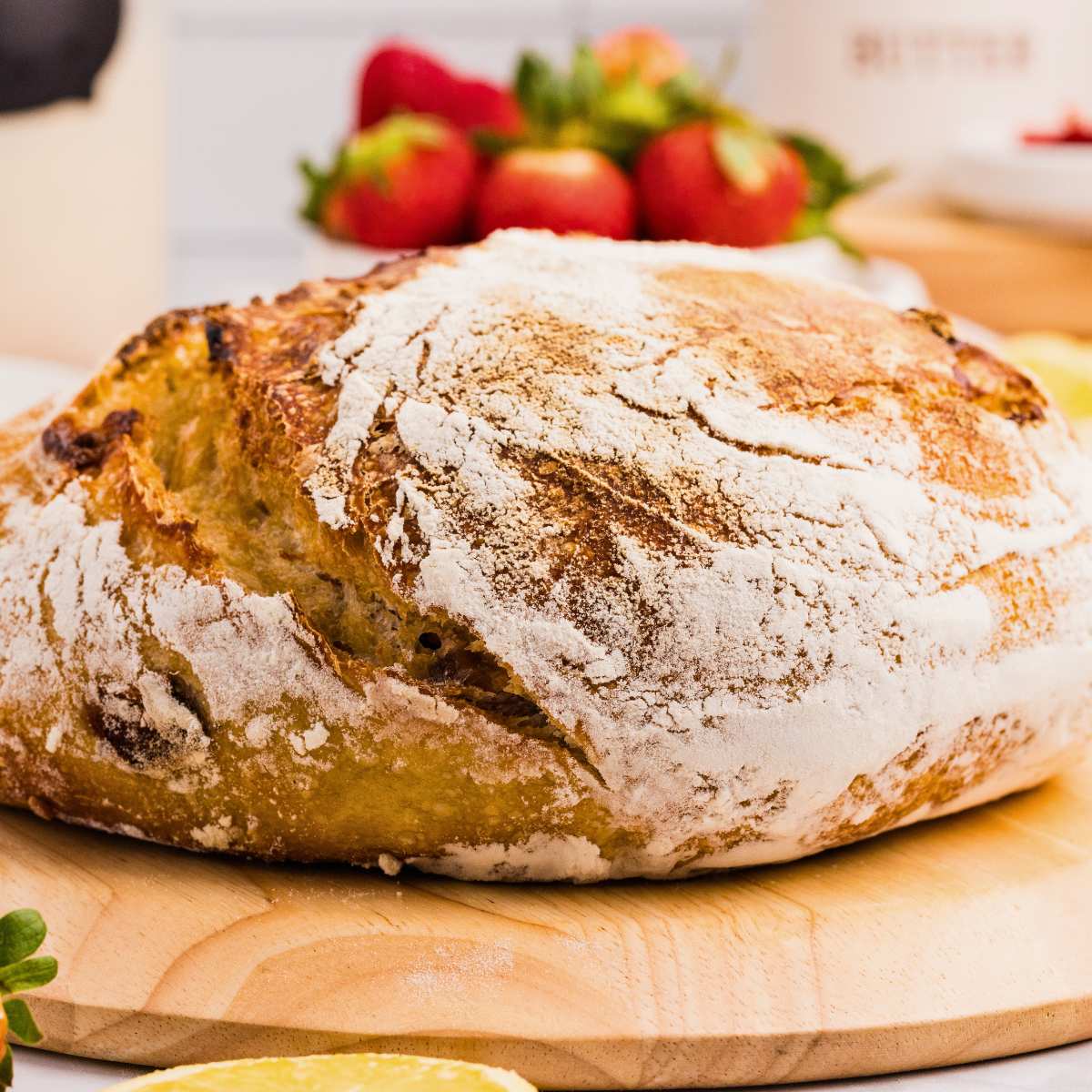 loaf of strawberry sourdough bread on wooden board.