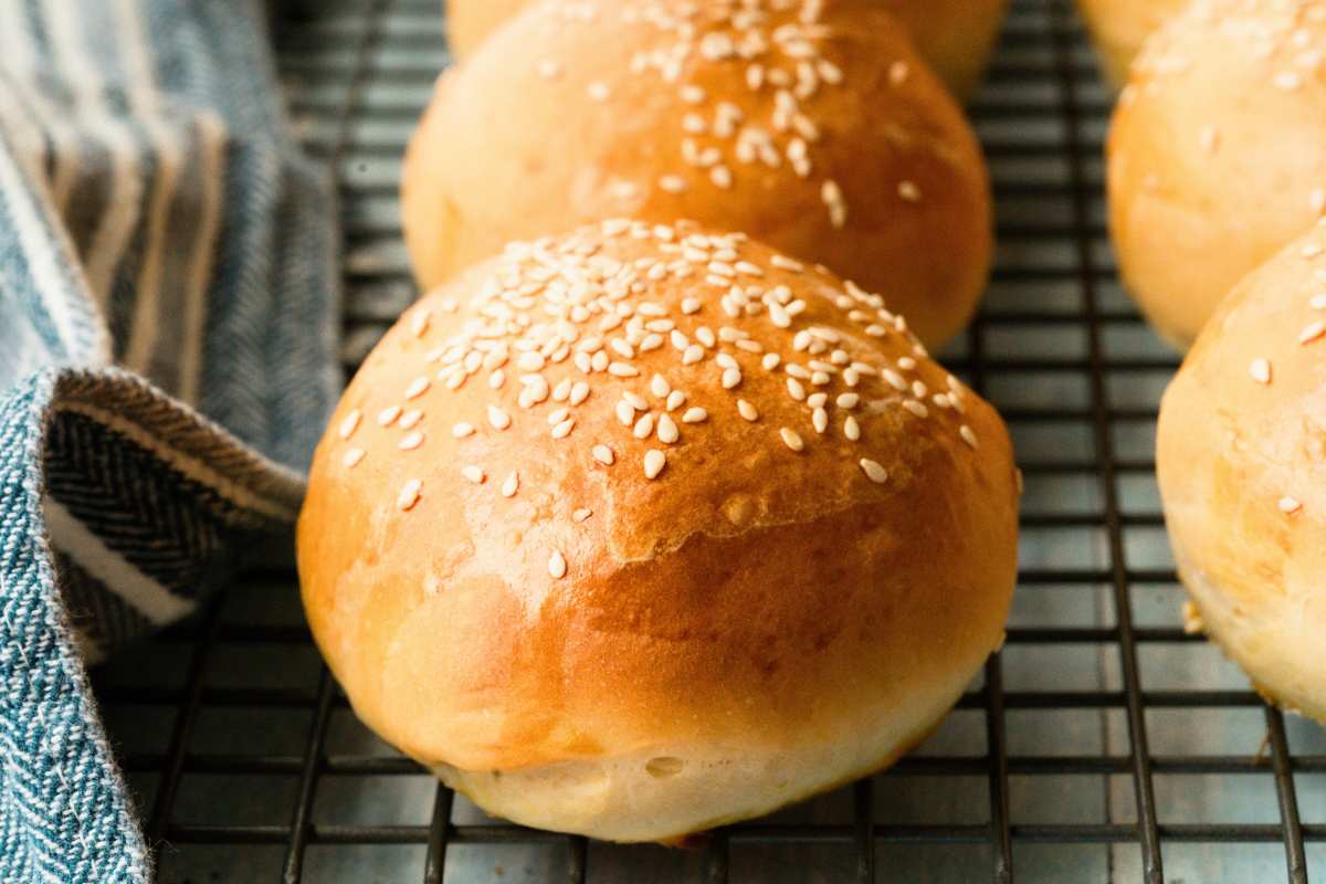 burger buns baked and cooling on wire rack.