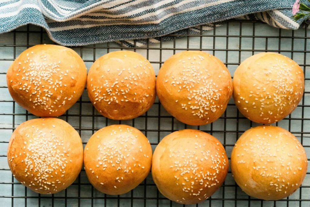 baked burger buns cooling on wire rack.