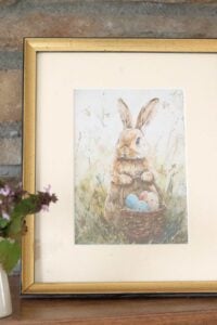 photograph of framed watercolor easter bunny in gold frame.