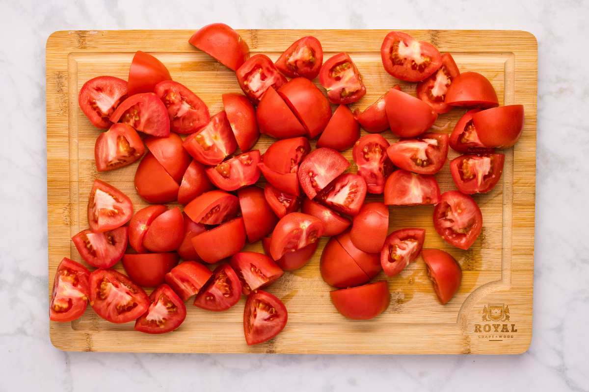 Chopped tomatoes on a wooden cutting board.