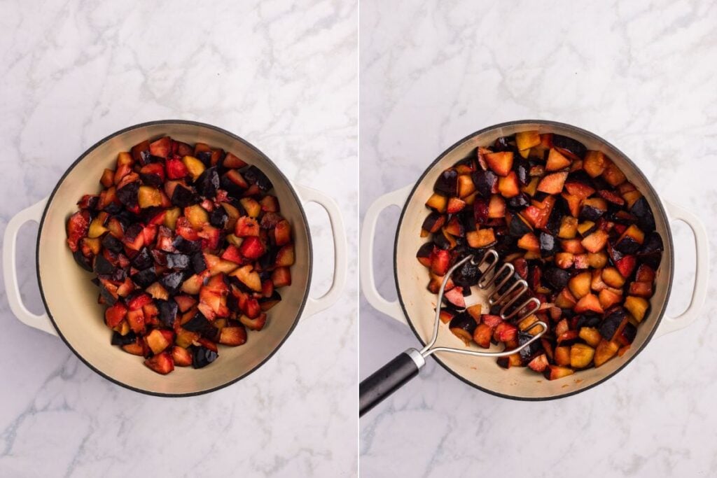 Chopped plums in a pot, then partially mashed with a potato masher.