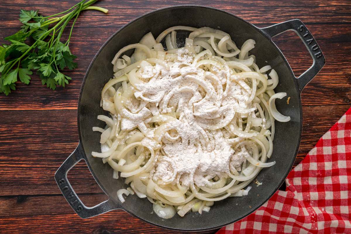 Seasoned flour sprinkled over sautéed onions.