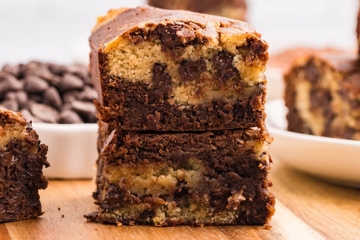 Two stacked brookie squares on a wooden surface.