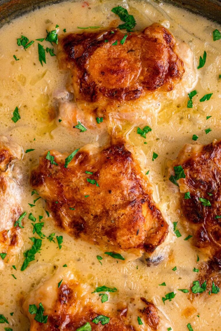 finished smothered chicken garnished with parsley.
