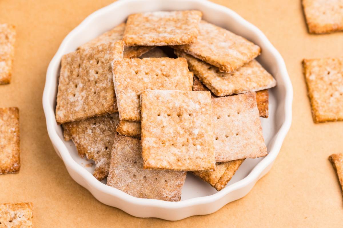 Baked sourdough wheat crackers in a white dish.