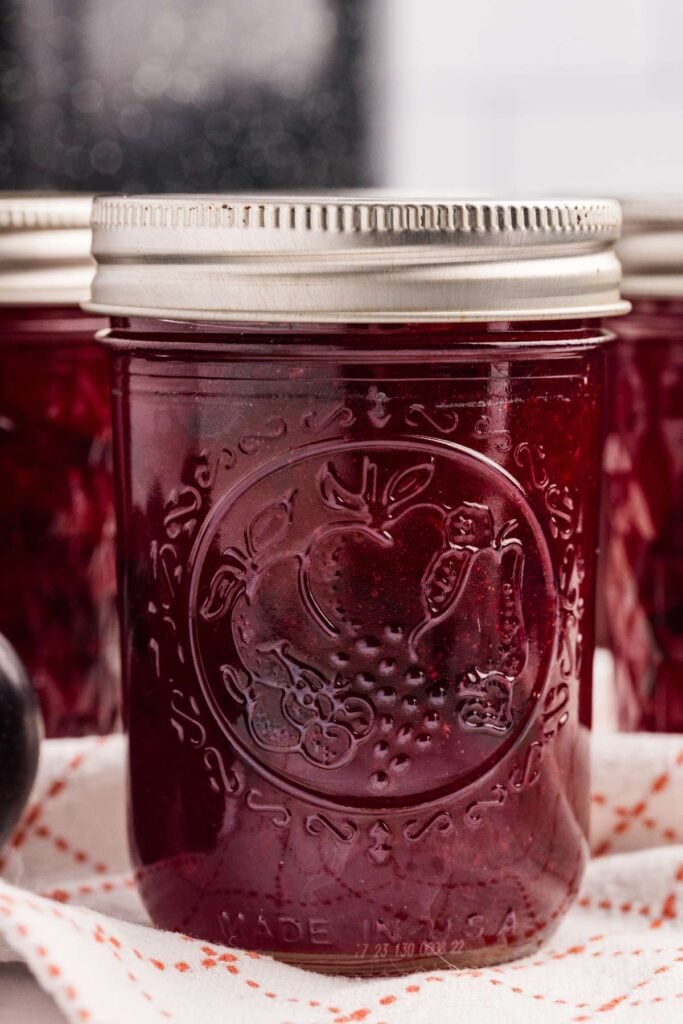 plum jam in front of top black canner.