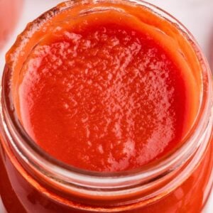 overhead view of smooth tomato sauce in jar.