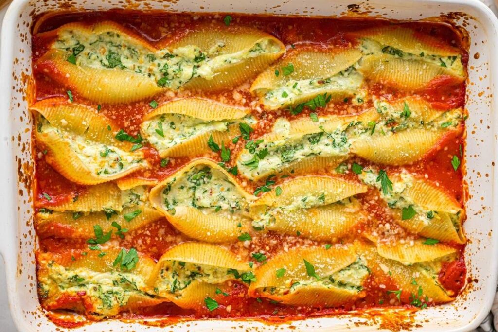 Pan of baked spinach ricotta stuffed shells.