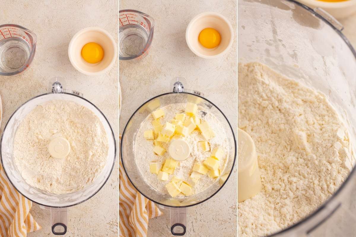 Food processor bowl showing crumbly pastry dough mixture being formed.