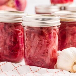 close up view of jars of pickled onion on tea towel