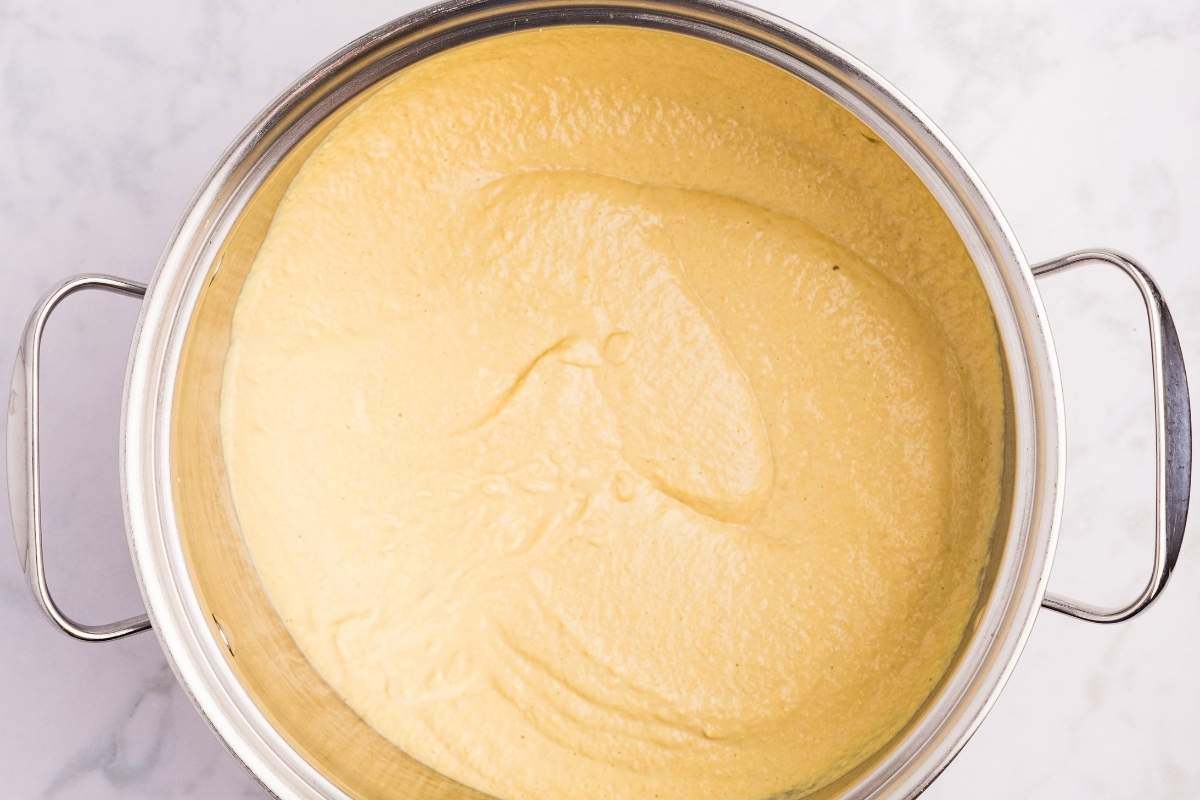 Large pot with smooth yellow mustard mixture ready for final cooking.
