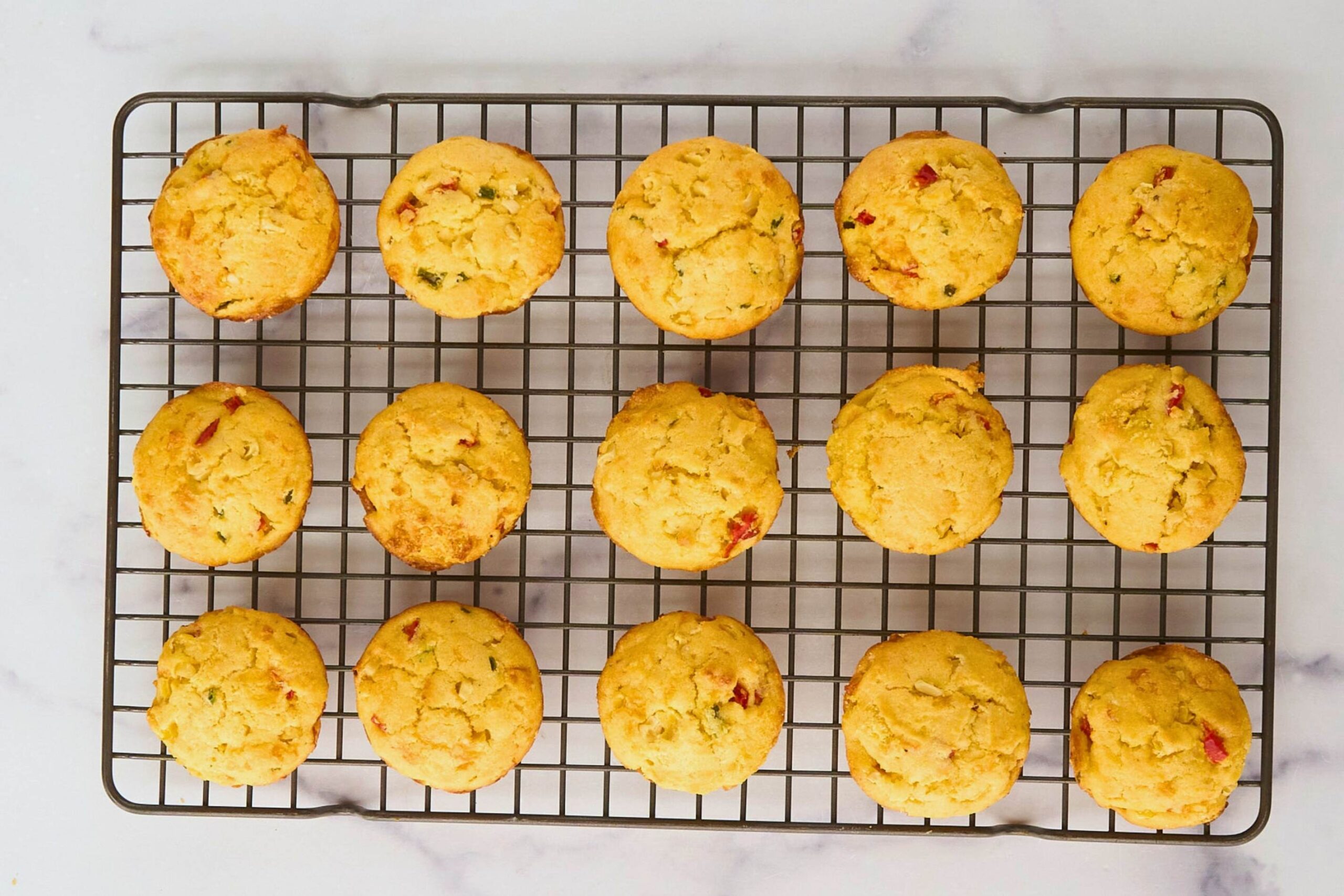 12 corn muffins on cooling rack.