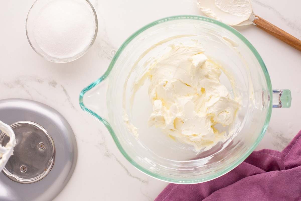 cream cheese in glass mixing bowl.