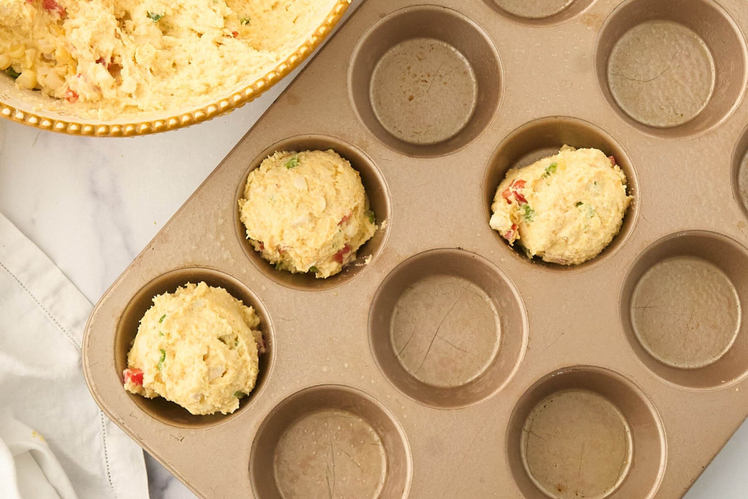 muffin tin filled with batter