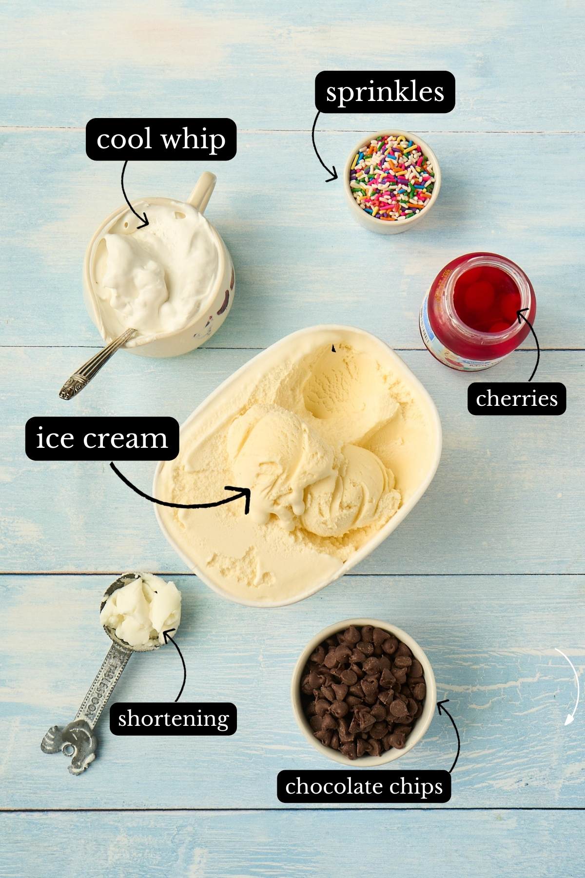 Ingredients for ice cream squares laid out including ice cream, chocolate chips and toppings.