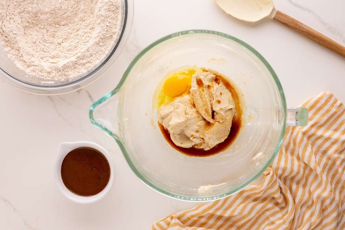 Creamed butter mixture with egg and molasses in mixer bowl.