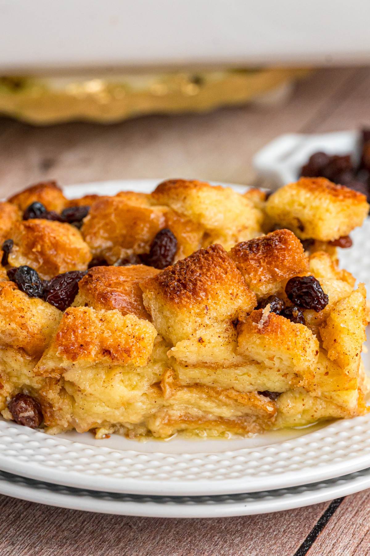Side view of bread pudding slice showing crispy top and custard center.