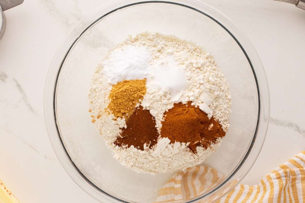 flour in large glass bowl with spices on top
