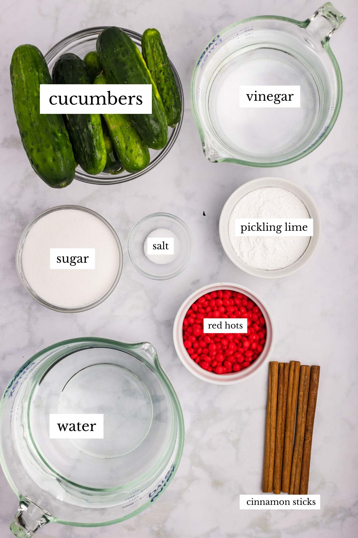Ingredients for cinnamon pickles arranged on a counter with labels.