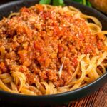 close up of sauce over pasta.