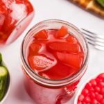 overhead view of open jar red pickles.