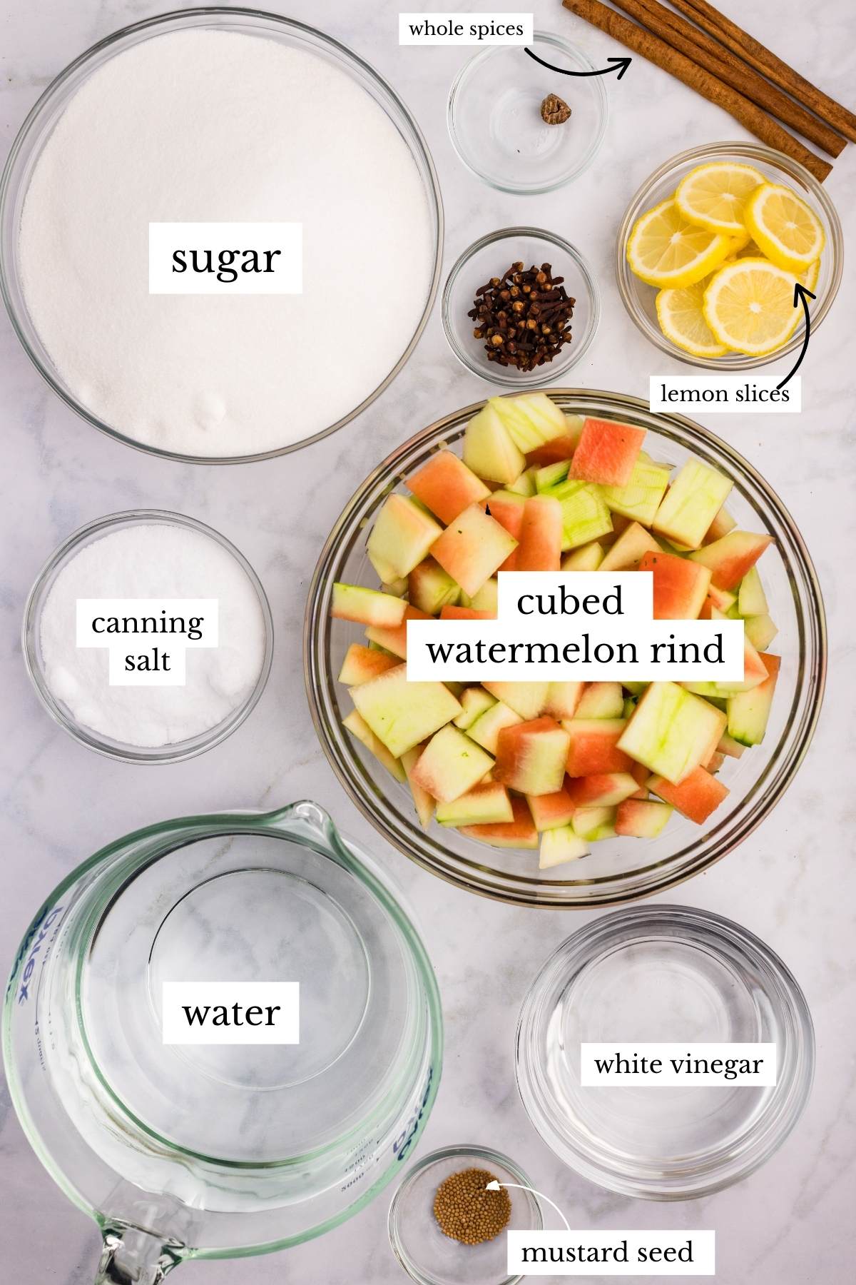 Ingredients for watermelon rind pickles including cubed rind, sugar, spices, lemon slices, and vinegar.