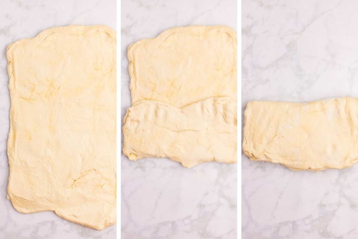Dough rolled out on a floured parchment surface and folded into thirds for layering.