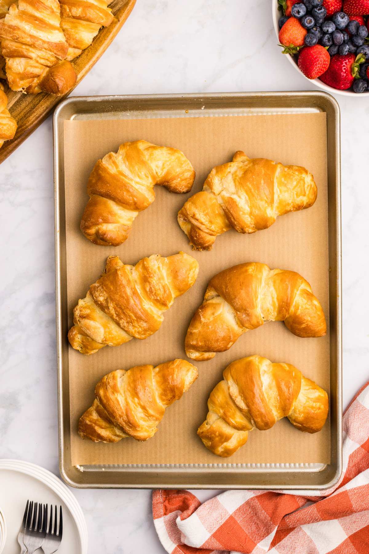 overhead view of finished croissants on baking sheet.