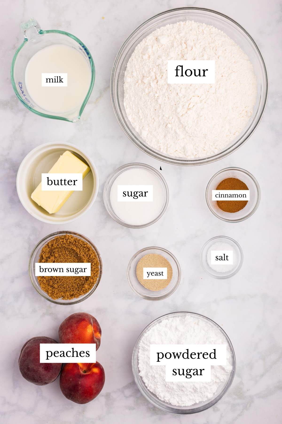 Overhead view of labeled ingredients for peach cobbler cinnamon rolls.