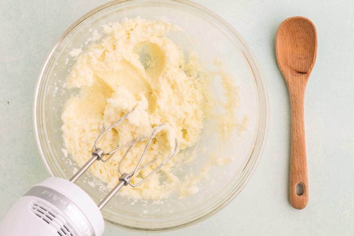 overhead view of hand mixer creaming butter and sugar.