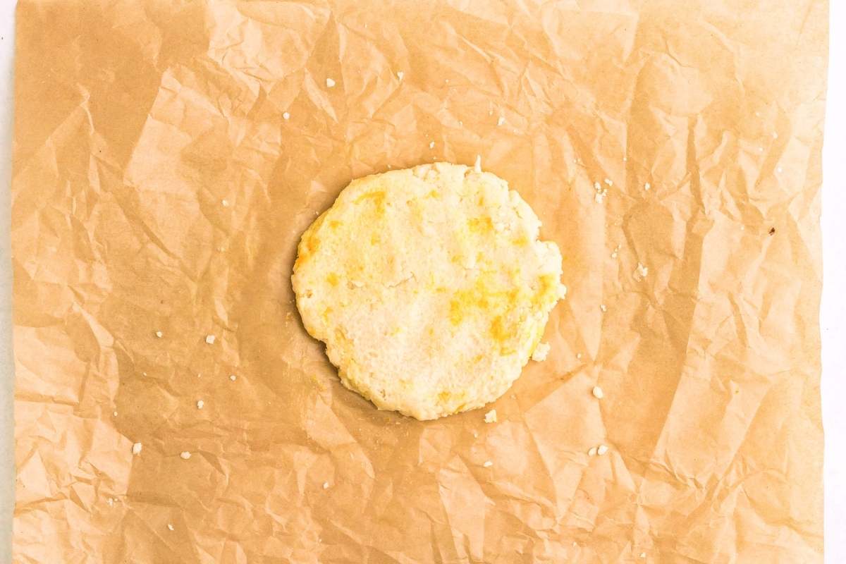 Dough disk of lemon shortbread on parchment paper.