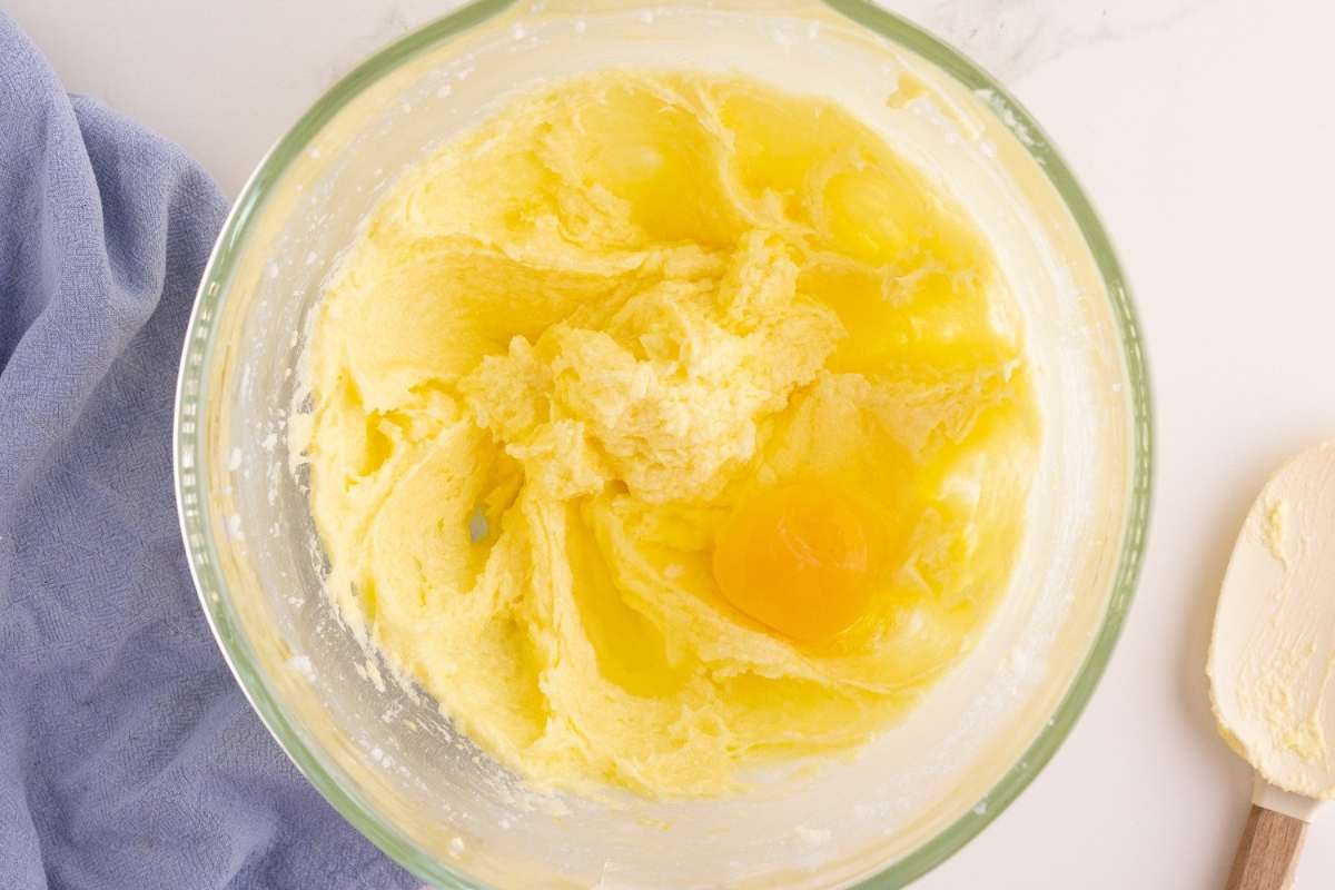 eggs partially added to mixing bowl.