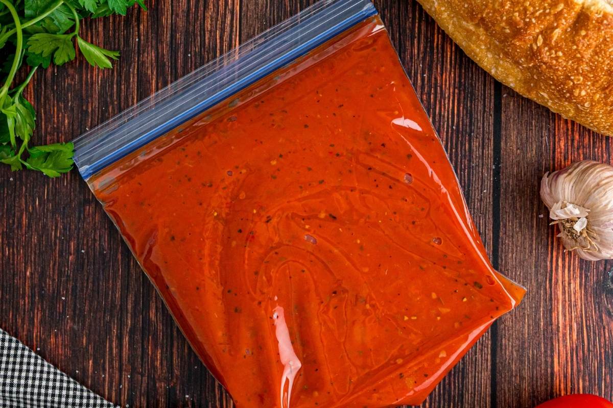 marinara on wooden counter in plastic bag