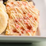 Close-up of peppermint shortbread cookies with drizzled white chocolate.