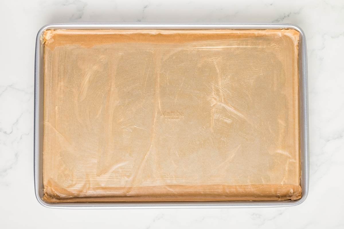 buttered parchment paper on baking sheet