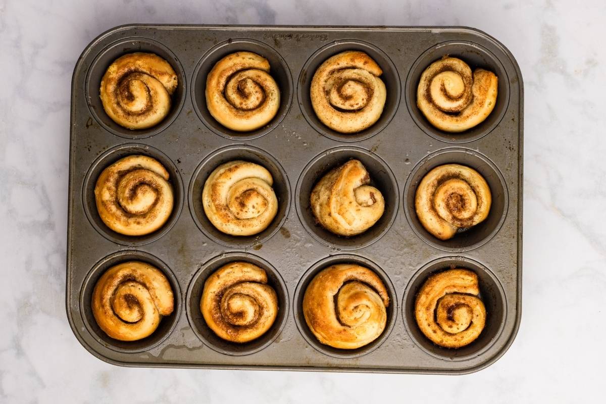 Fully baked buns in muffin tin.