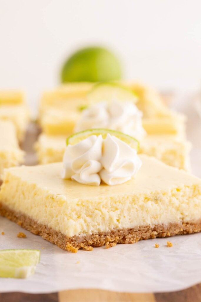 close up of key lime bars on white plate.
