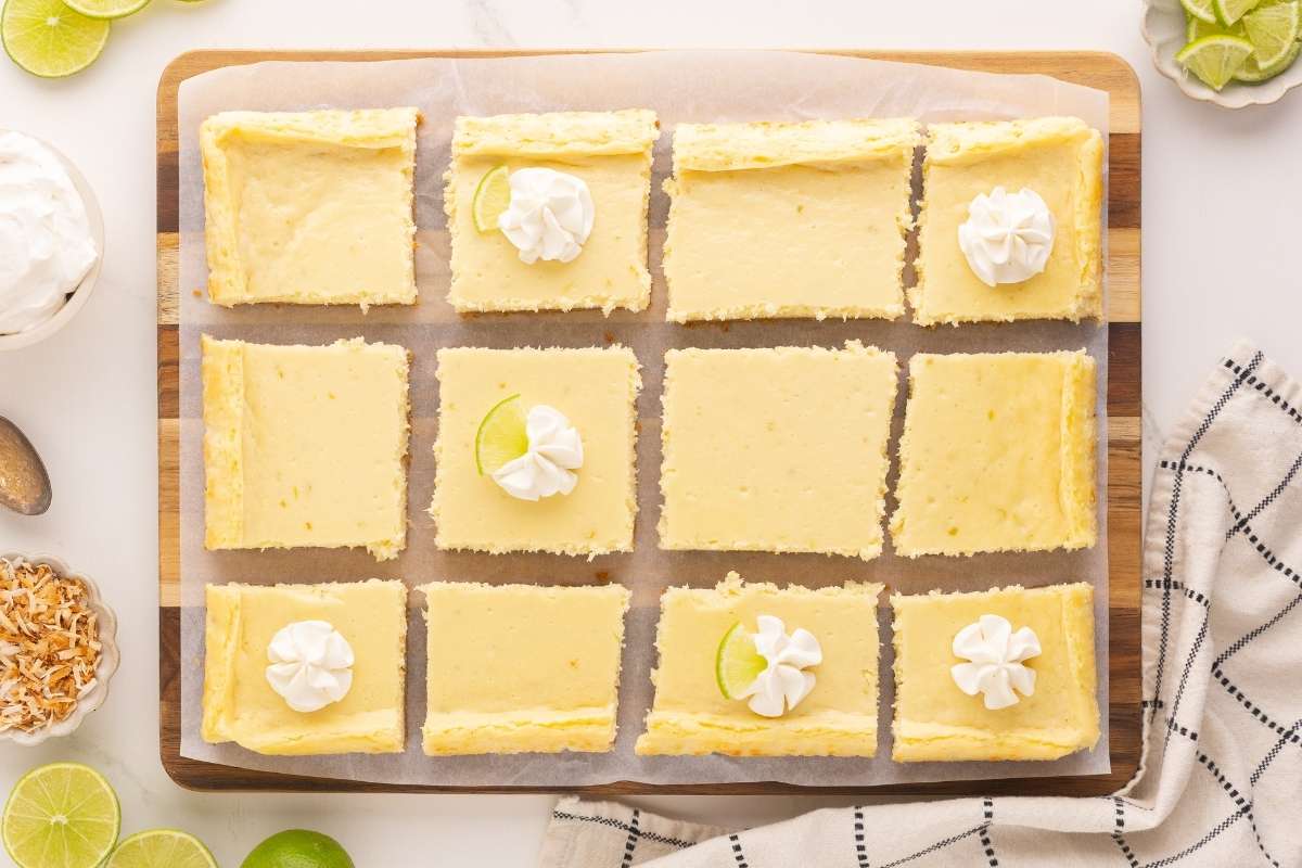 overhead view of cheesecake bars cut into squares and garnished.